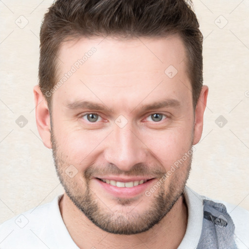 Joyful white young-adult male with short  brown hair and grey eyes