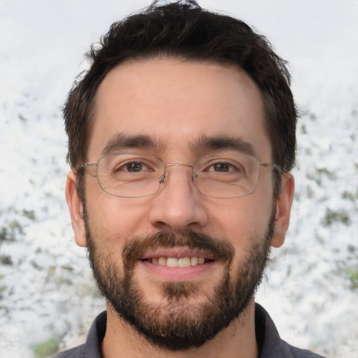 Joyful white adult male with short  brown hair and brown eyes