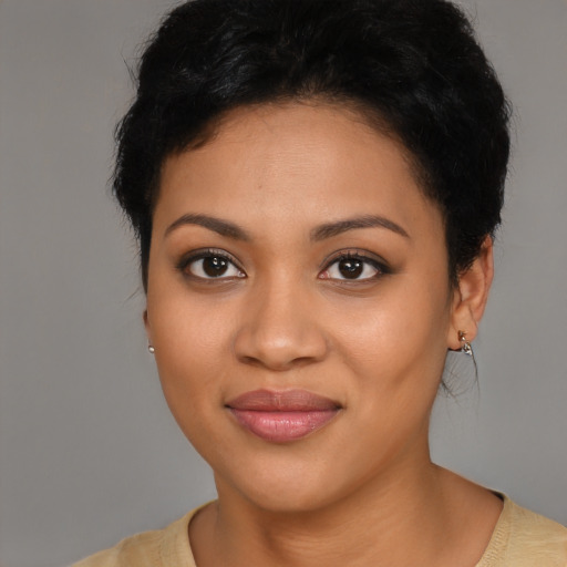 Joyful latino young-adult female with short  black hair and brown eyes