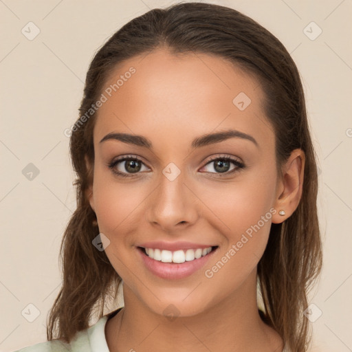 Joyful white young-adult female with long  brown hair and brown eyes