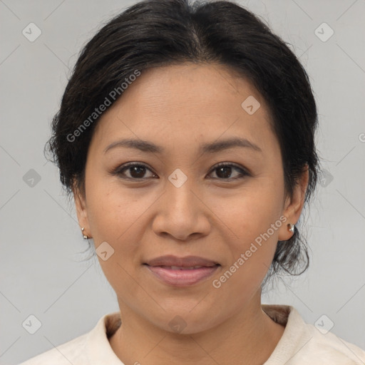 Joyful asian adult female with medium  brown hair and brown eyes