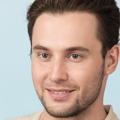 Joyful white young-adult male with short  brown hair and brown eyes