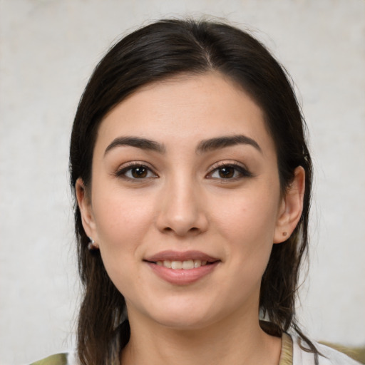 Joyful white young-adult female with medium  brown hair and brown eyes