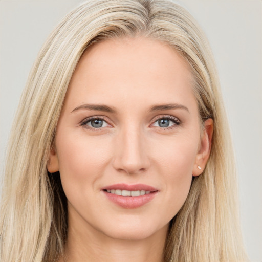 Joyful white young-adult female with long  brown hair and blue eyes