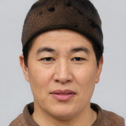 Joyful asian adult male with short  brown hair and brown eyes