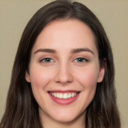 Joyful white young-adult female with long  brown hair and green eyes