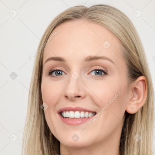 Joyful white young-adult female with long  brown hair and blue eyes