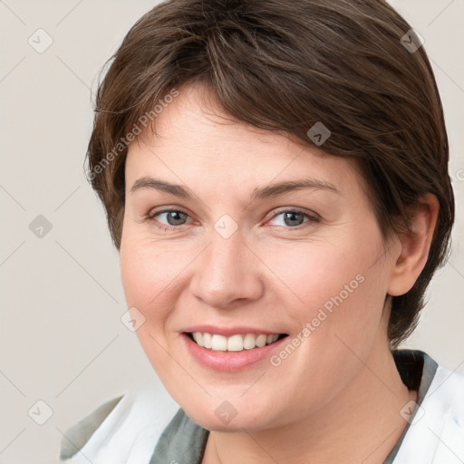 Joyful white young-adult female with medium  brown hair and grey eyes