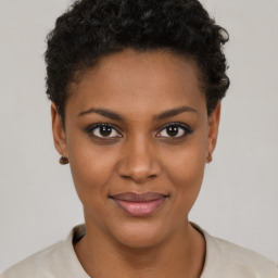 Joyful black young-adult female with short  brown hair and brown eyes