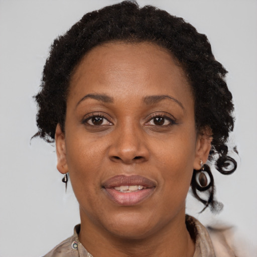 Joyful black adult female with short  brown hair and brown eyes