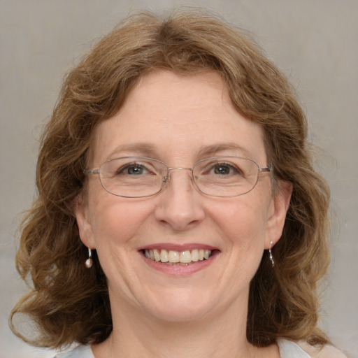 Joyful white adult female with medium  brown hair and blue eyes