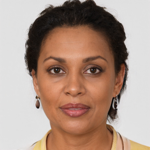 Joyful latino adult female with short  brown hair and brown eyes