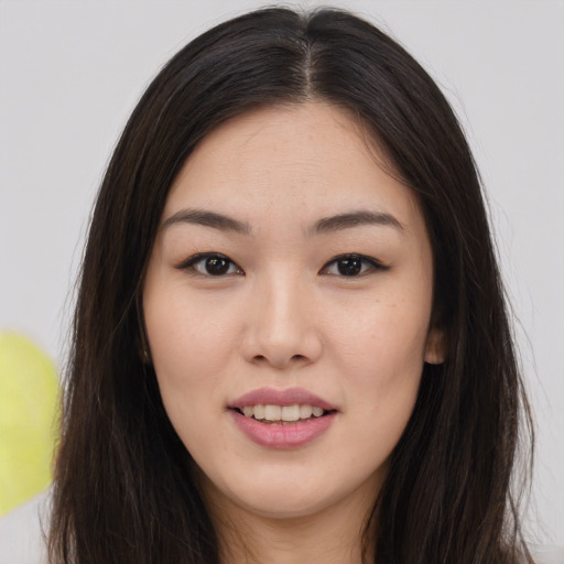 Joyful asian young-adult female with long  brown hair and brown eyes