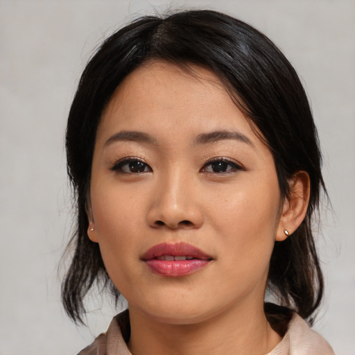 Joyful asian young-adult female with medium  black hair and brown eyes