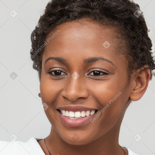 Joyful black young-adult female with short  brown hair and brown eyes