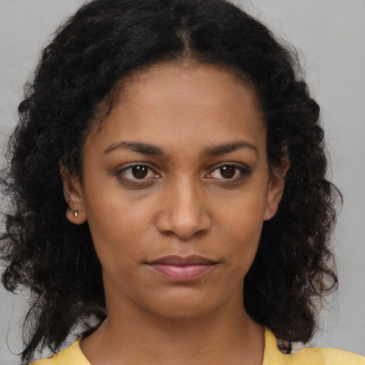 Neutral black young-adult female with medium  brown hair and brown eyes