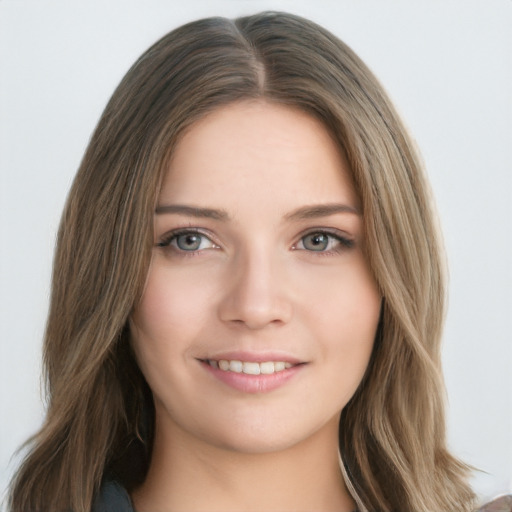 Joyful white young-adult female with long  brown hair and blue eyes