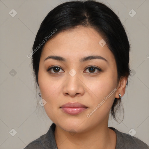 Joyful latino young-adult female with medium  brown hair and brown eyes