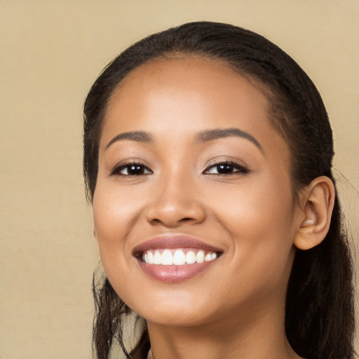 Joyful white young-adult female with long  black hair and brown eyes