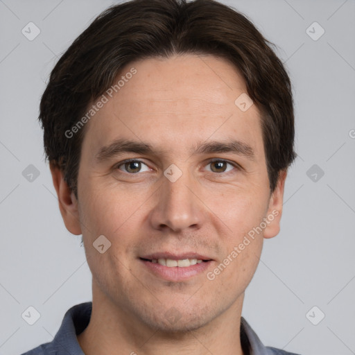 Joyful white adult male with short  brown hair and grey eyes