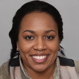 Joyful black young-adult female with medium  brown hair and brown eyes