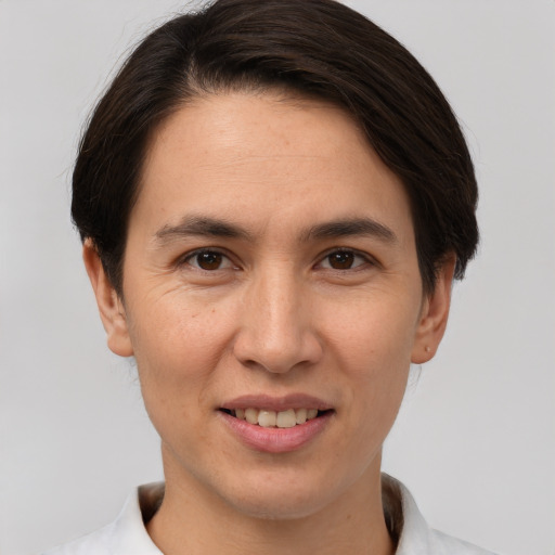 Joyful white young-adult female with short  brown hair and brown eyes