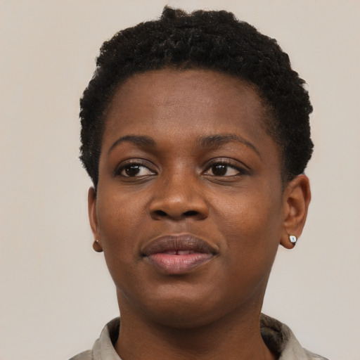 Joyful black young-adult female with short  brown hair and brown eyes