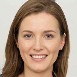 Joyful white young-adult female with long  brown hair and grey eyes