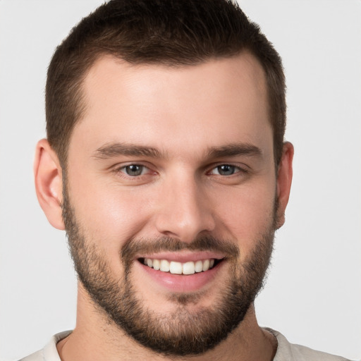 Joyful white young-adult male with short  brown hair and brown eyes