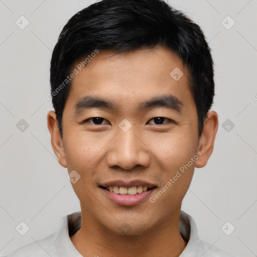 Joyful asian young-adult male with short  black hair and brown eyes