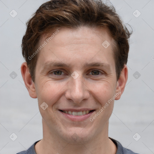 Joyful white adult male with short  brown hair and grey eyes