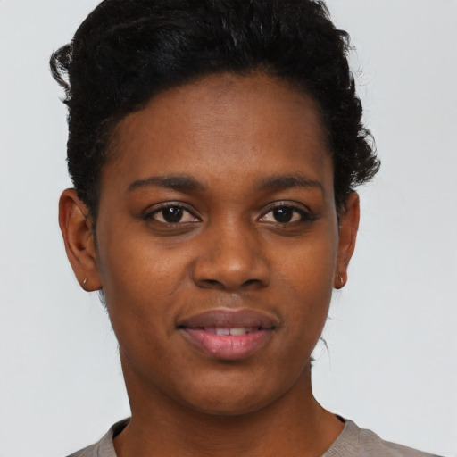 Joyful black young-adult female with short  brown hair and brown eyes