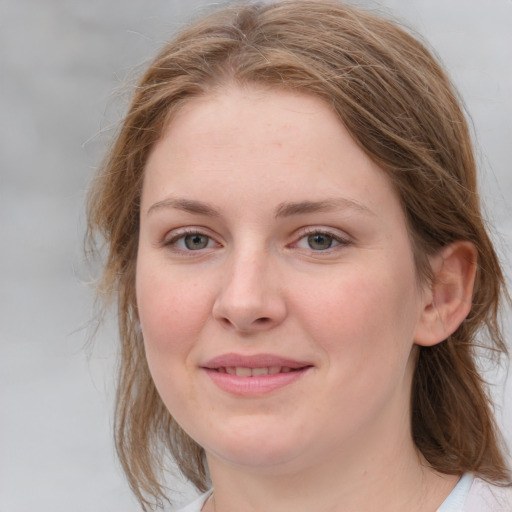 Joyful white young-adult female with medium  brown hair and blue eyes