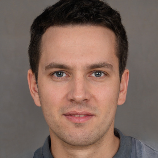 Joyful white adult male with short  brown hair and brown eyes