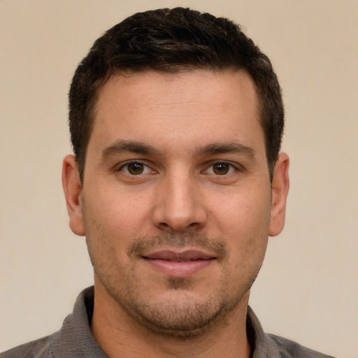 Joyful white young-adult male with short  brown hair and brown eyes