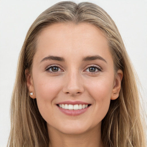 Joyful white young-adult female with long  brown hair and grey eyes