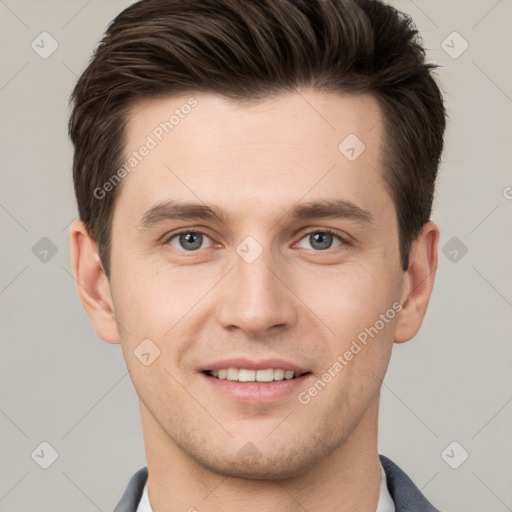 Joyful white young-adult male with short  brown hair and grey eyes