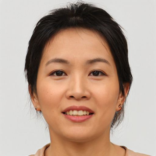 Joyful asian young-adult female with medium  brown hair and brown eyes