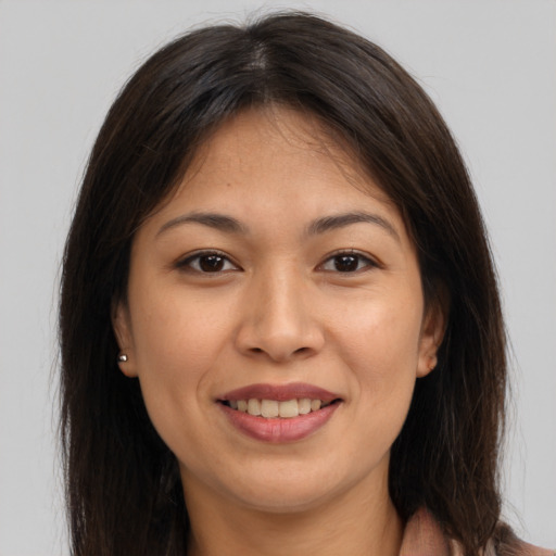 Joyful asian young-adult female with long  brown hair and brown eyes