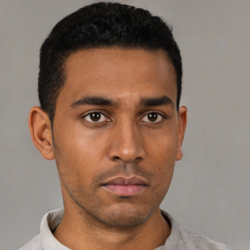 Neutral latino young-adult male with short  black hair and brown eyes