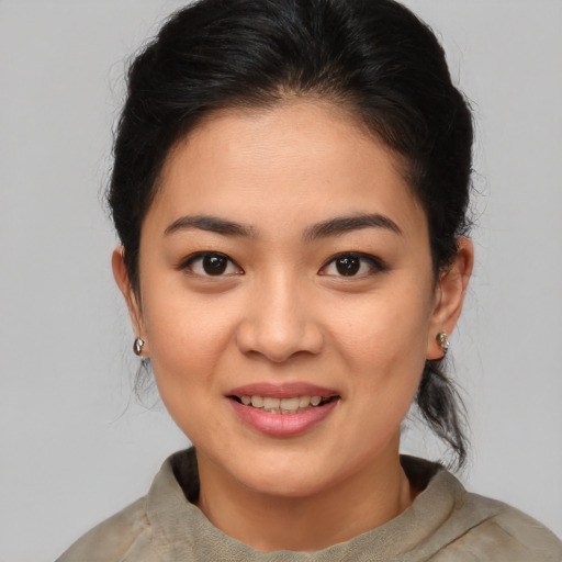 Joyful asian young-adult female with medium  brown hair and brown eyes
