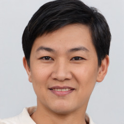 Joyful asian young-adult male with short  brown hair and brown eyes