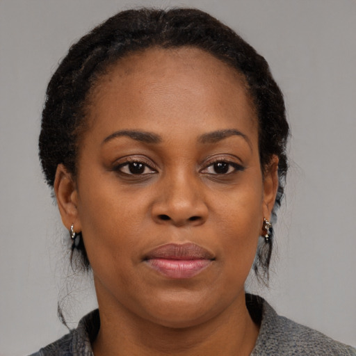 Joyful black young-adult female with medium  brown hair and brown eyes
