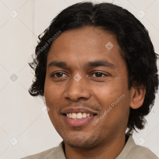 Joyful latino young-adult male with short  black hair and brown eyes