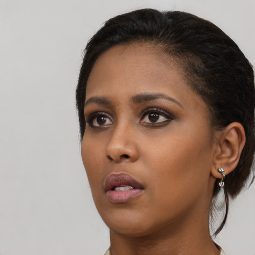 Neutral black young-adult female with medium  black hair and brown eyes