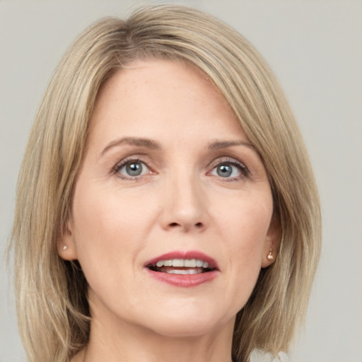 Joyful white adult female with medium  brown hair and grey eyes