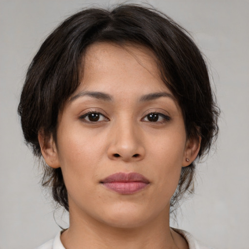 Joyful asian young-adult female with medium  brown hair and brown eyes