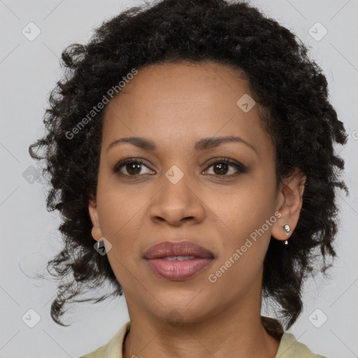 Joyful black adult female with medium  brown hair and brown eyes