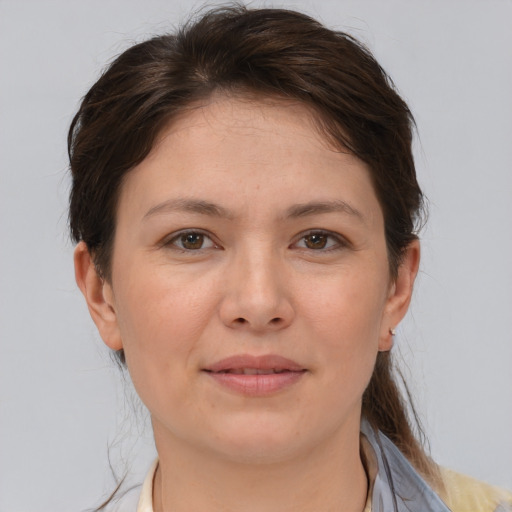 Joyful white young-adult female with medium  brown hair and brown eyes