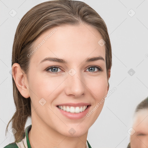 Joyful white young-adult female with medium  brown hair and green eyes